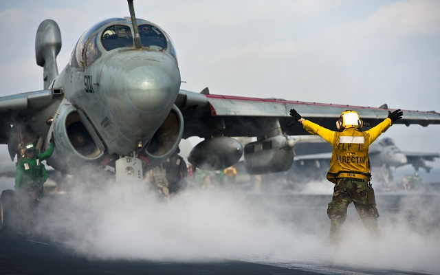 An EA-6B Prowler is about to launch from a US Navy Carrier with AN/ALQ-99 Low Band Transmitters