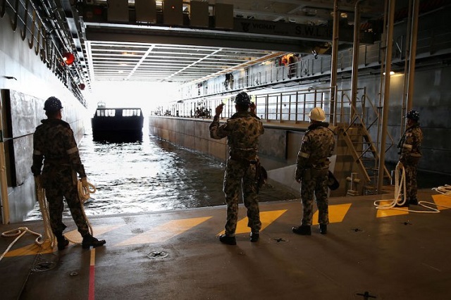 The idea of a ship letting 4,200 tonnes, or 4.2 million litres of water into a large space inside its stern may sound crazy, but for the Landing Helicopter Dock, that is exactly what happens when the ship 'docks down'. Docking down allows the ship to get into a position to launch or recover its landing craft, of which it can house four. Canberra’s Engineering Officer, Commander David Walter, explained the process in simple terms.