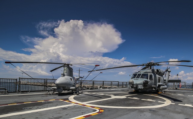 The "Wildcards" of U.S. Navy Helicopter Sea Combat Squadron (HSC) 23 made history Sept. 14 when they used a MQ-8B unmanned air system as a laser designator platform for a MH-60S Seahawk helicopter to fire a AGM-114N Hellfire missile.
