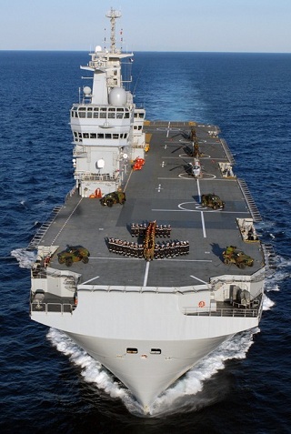 Designed by DCNS, Mistral BPC (Bâtiment de Projection et de Commandment) LHD is a multi-mission 21,500t amphibious assault, command and power projection ship. Mistral-class vessels are capable to accomodate and deploy 16 transport or attack helicopters, four landing crafts, up to 70 vehicles or 13 main battle tanks. They have accomodations for 450 to 700 troops. Each ship of the class is equipped with a 69-bed hospital.