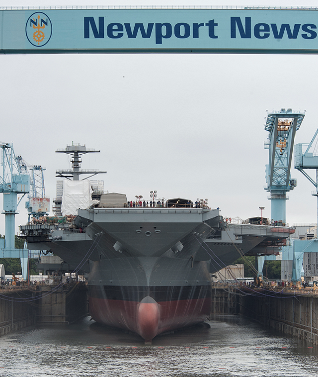 Huntington Ingalls Industries (HII) announced today that its Newport News Shipbuilding (NNS) division began flooding the dry dock where the aircraft carrier Gerald R. Ford (CVN 78) has been under construction since November 2009. With the push of a dozen buttons, ship’s sponsor Susan Ford Bales initiated the flow of more than 100 million gallons of water into the dry dock.