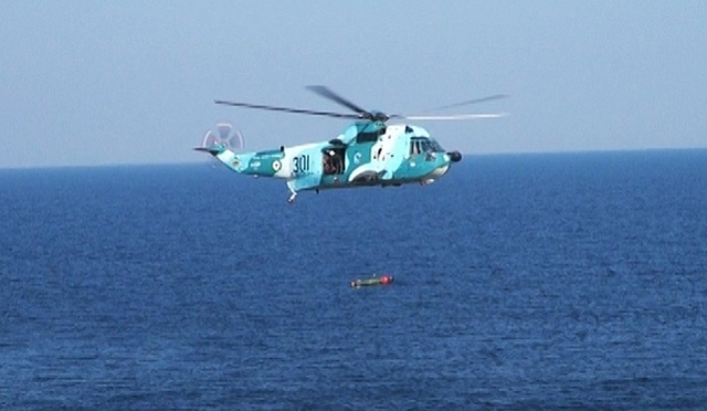 An Iranian Navy SH-3D anti-submarine helicopter launches the latest Iranian made torpedo during Mohammad Rasoulallah exercise
