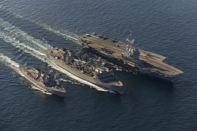 The guided-missile destroyer USS Bulkeley (DDG 84), left, and the French navy aircraft carrier Charles de Gaulle (R 91), right, conduct an underway replenishment with the Military Sealift Command fleet replenishment oiler USNS Arctic (T-AOE 8). Charles de Gaulle is conducting operations with the Harry S. Truman Carrier Strike Group