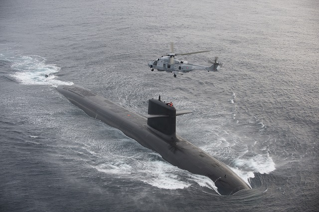 An NH90 NFH Caiman transfers personnel on board French Navy Le Triomphant class SSBN.